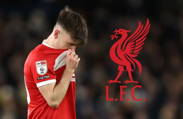 Ben Doak covers his face with his shirt next to Liverpool club crest.