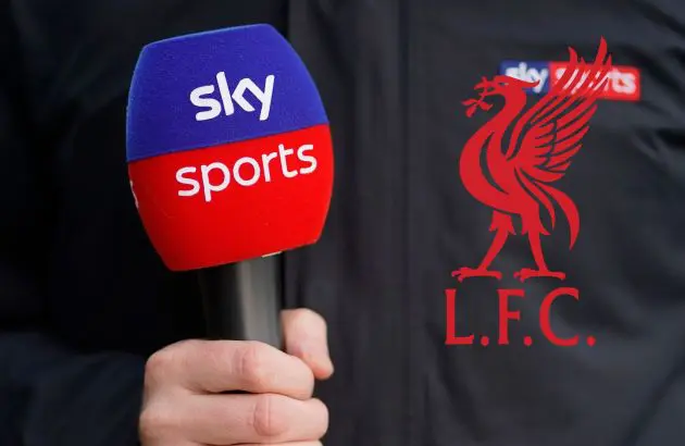 Journalist holds Sky Sports microphone next to Liverpool club crest.
