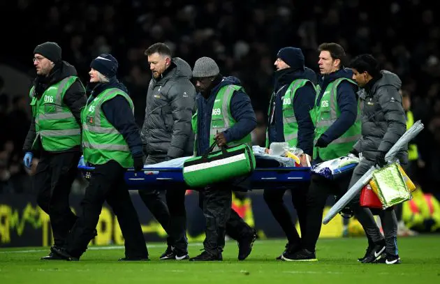 Medical staff take Tottenham star Rodrigo Bentancur off the pitch on a stretcher.