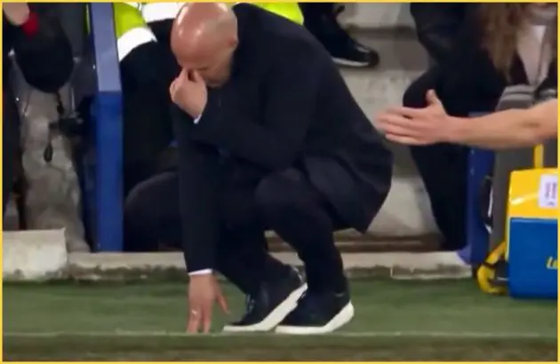 Liverpool head coach Arne Slot drops to the ground during Merseyside derby.