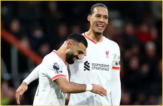 Mo Salah and Virgil van Dijk laugh with each other on the pitch.