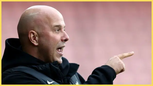 Arne Slot points at something in the distance at the Vitality Stadium.