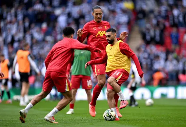 Liverpool players warm up ahead of the Carabao Cup final