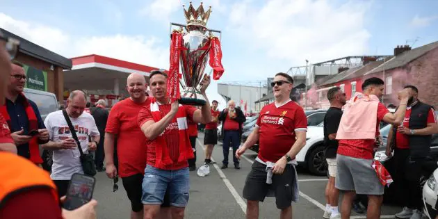 Liverpool fans celebrate with a replica Premier League trophy