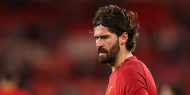Alisson Becker warms up for Liverpool