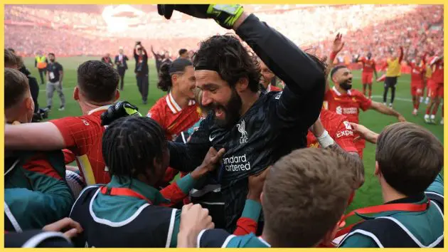 Alisson Becker embraces Liverpool ball boys after Premier League title win.