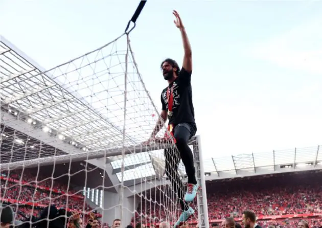 Alisson Becker celebrates after Liverpool received the Premier League trophy