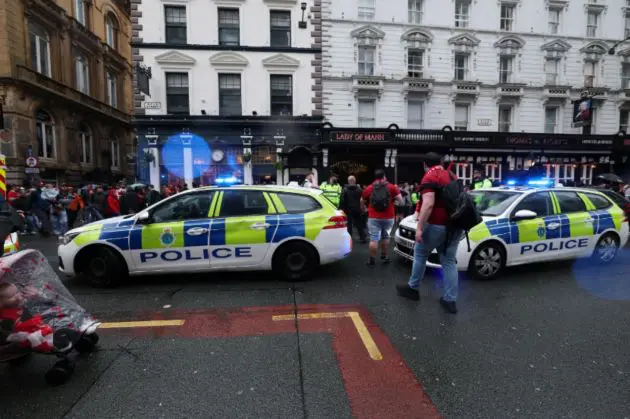 Police attend to the scene of the car crash in Liverpool on Monday evening