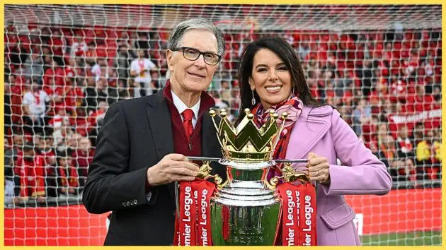 John W Henry and his wife Linda Pizzuti Henry hold the Premier League trophy.