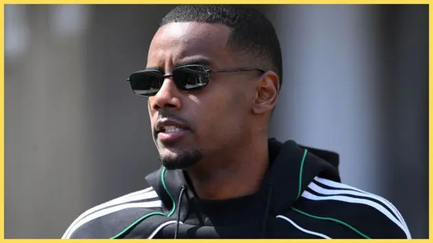 Alexander Isak wears sunglasses and grimaces.