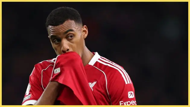 Ryan Gravenberch wipes his face with his Liverpool shirt.