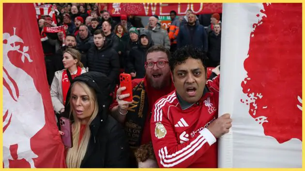 Liverpool fans look on open-mouthed from the stands.