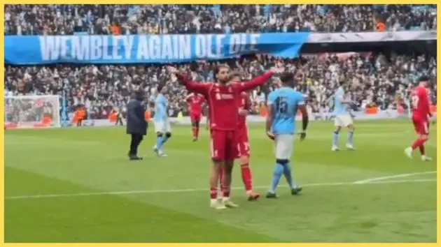 Dominik Szoboszlai gestures towards Liverpool fans in the Etihad Stadium