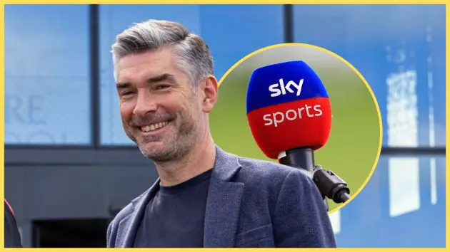 Richard Hughes smiles next to Sky Sports microphone.