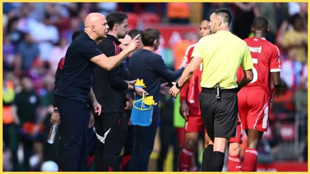 Arne Slot speaks with Andy Madley after Daniel Munoz's goal at Anfield