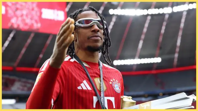 Bayern Munich winger Michael Olise raises his right hand.