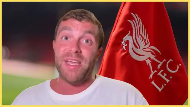 Fabrizio Romano speaks in front of Liverpool flag.
