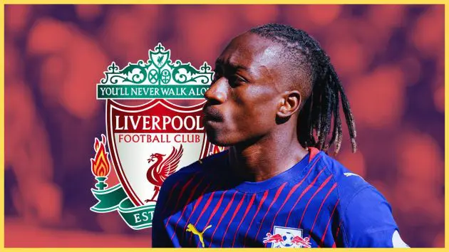 Yan Diomande looks on during RB Leipizg game in front of Liverpool badge.