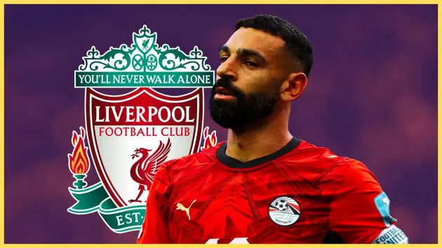 Mo Salah looks on in front of Liverpool club crest.