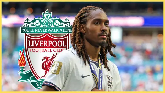 Tottenham fullback Djed Spence holds his third placed World Cup medal in front of Liverpool club crest.