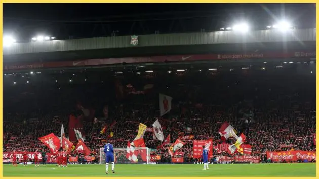 Liverpool fans in the Kop display flags and banners